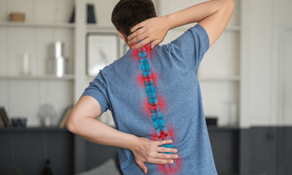 A person with a blue and red highlighted spine, showing areas of pain, while holding their neck and lower back in discomfort.
